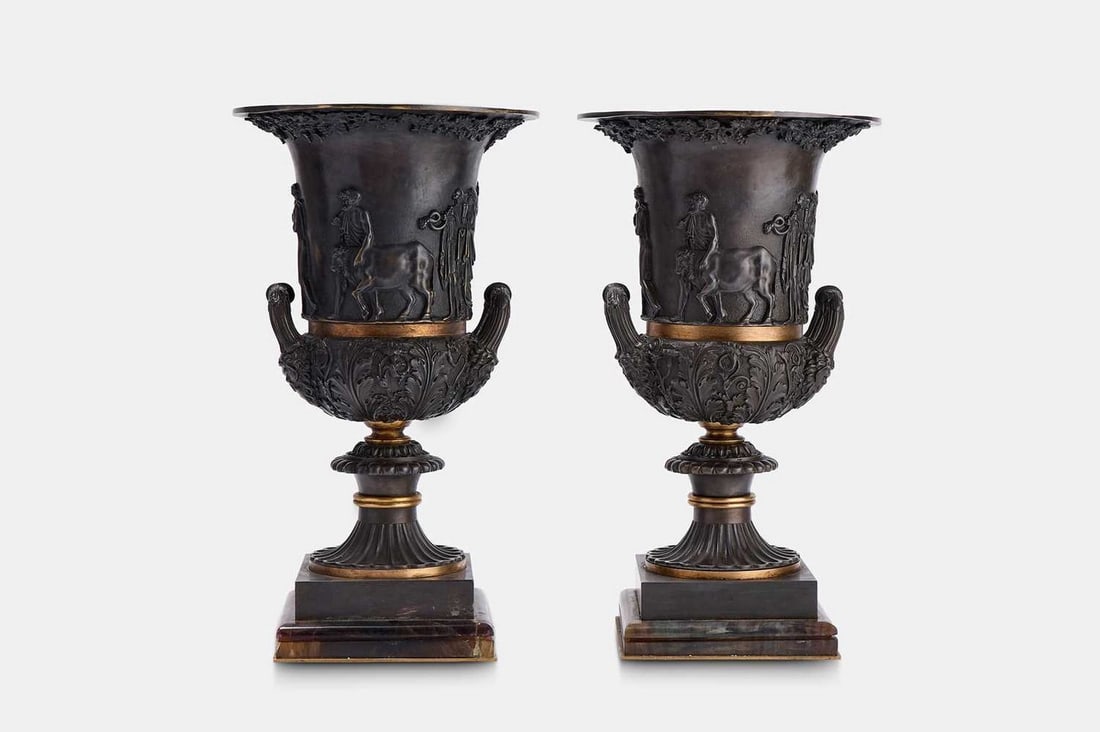 A pair of grand tour patinated bronze and fluorspar Medici vases, late 19th/early 20th century,: A pair of grand tour patinated bronze and fluorspar Medici vases, late 19th/early 20th century, each of campana form, the body centred by a processional figural scene, flanked by handles terminating i