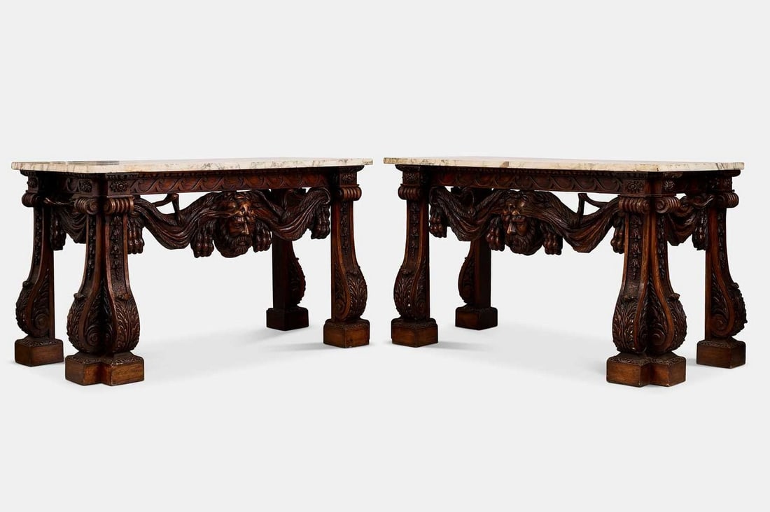 A pair of George II-style carved wooden pier tables, 20th century, after a design by Matthias Lock,: A pair of George II-style carved wooden pier tables, 20th century, after a design by Matthias Lock, each with a veined white marble top, over a frieze set with egg-and-dart moulding and Vitruvian scro