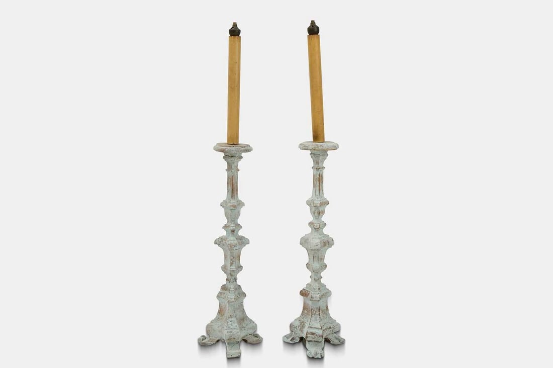 A pair of painted wood candlesticks, 18th century and later, (1 of 3)