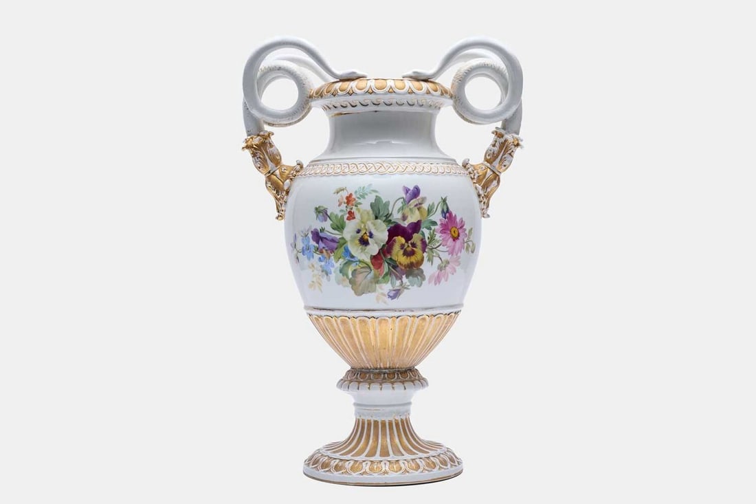 A large Meissen porcelain vase, first quarter of the 20th century,: A large Meissen porcelain vase, first quarter of the 20th century, with twin handles in the forms of snakes, the body decorated with floral sprays and gilt highlights, raised on a fluted circular base