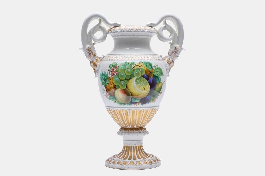 A large Meissen porcelain vase, circa 1860,: A large Meissen porcelain vase, circa 1860, with handles in the form of snakes, the body decorated with fruit, foliage and gilt highlights, raised on a fluted circular base, marks to base (35cm wide, 