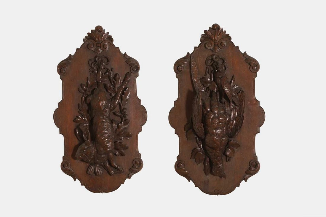 Two Black Forest carved wall sculptures, 20th century, German,: Two Black Forest carved wall sculptures, 20th century, German, depicting a game bird and hare, mounted on scrolling cartouche plaques (39cm wide, 69cm high) (2) Condition Report: Both with light gener