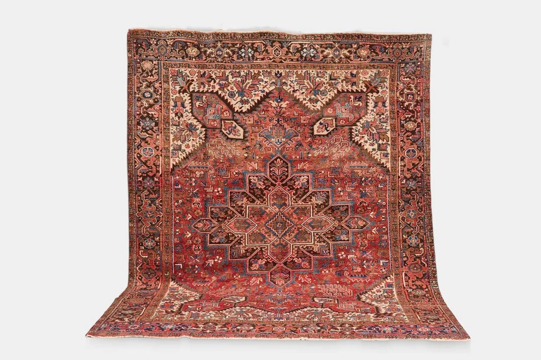A Heriz wool carpet, 20th century, Persian,: A Heriz wool carpet, 20th century, Persian, woven with geometric foliate motifs to a red ground (295 x 248cm) Condition Report: Overall the piece presents in very good structural and cosmetic conditio