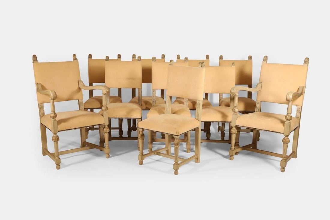 A set of ten painted oak dining chairs, circa 1900,: A set of ten painted oak dining chairs, circa 1900, each with lion mask finials and turned supports, with suede upholstery (elbow chair 58cm wide, 68cm deep, 102cm high) (10)