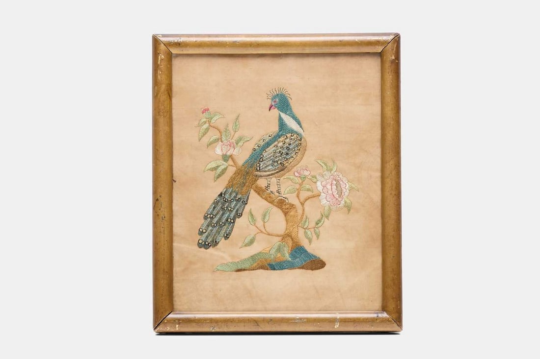 A Regency silkwork picture, early 19th century,: A Regency silkwork picture, early 19th century, depicting a peacock on a branch with flowers and leaves, stitched in polychrome silk threads (26.5 x 21.5cm; framed 31 x 26cm) Condition Report: Good to
