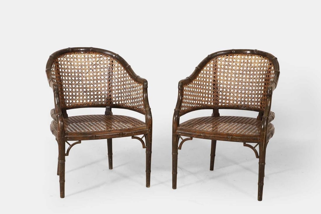 A pair of Regency-style beech bergère library armchairs, 20th century,: A pair of Regency-style beech bergère library armchairs, 20th century, each of tub form, the caned seat and back enclosed within a faux bamboo frame, raised on ring-turned tapering legs (58cm wide, 6