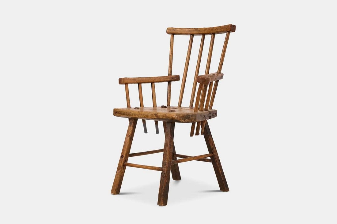 An ash stick-back chair, 19th century,: An ash stick-back chair, 19th century, with a thick slab seat, raised on splayed legs united by stretchers (59cm wide, 54cm deep, 85cm high) Condition Report: Moderate to significant general wear thro