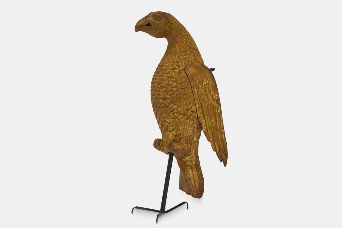 A carved giltwood dove, 19th century,: A carved giltwood dove, 19th century, modelled in an upright position, with a suspension ring affixed to the rear (12cm wide, 15cm deep, 34cm high)