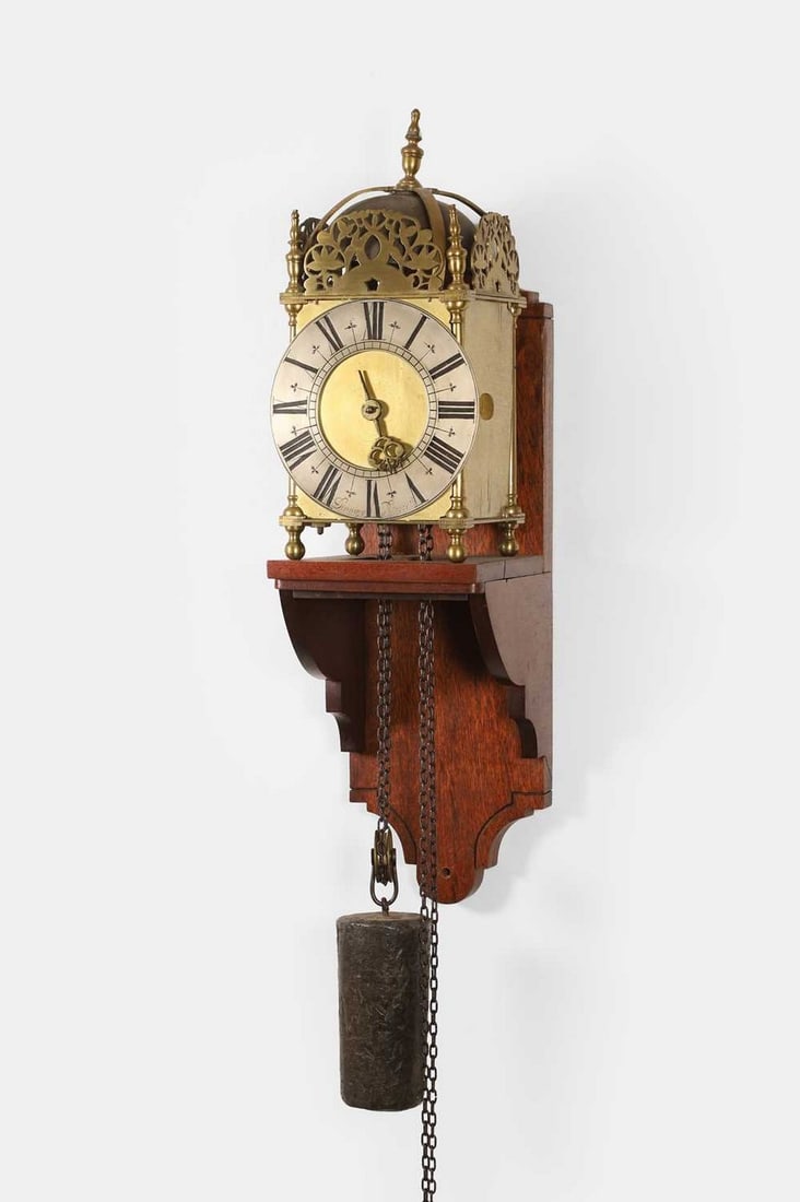 A brass lantern clock by William Donning, Petworth, first quarter of the 18th century,: A brass lantern clock by William Donning, Petworth, first quarter of the 18th century, the pierced four-pillar domed top surmounted by a turned finial, above a silvered Roman chapter ring flanked by l