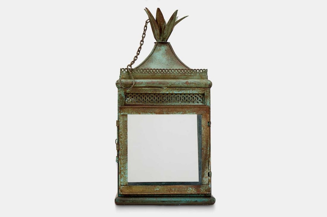 A Regency-style patinated metal hall lantern, 20th century,: A Regency-style patinated metal hall lantern, 20th century, of rectangular form, with a foliate finial and pierced detail, with four glass panes enclosing a pricket candle sconce (30.5cm wide, 30.5cm 