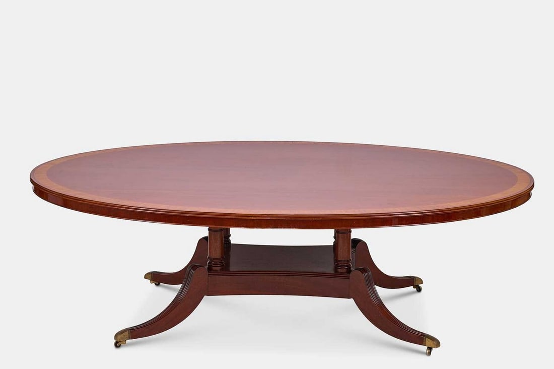 A Regency-style mahogany and rosewood dining table, 20th century, (1 of 4)