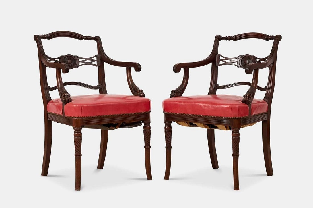 A pair of Regency mahogany elbow armchairs, circa 1820, probably Irish, in the manner of Mack,: A pair of Regency mahogany elbow armchairs, circa 1820, probably Irish, in the manner of Mack, Williams & Gibton, each turned reeded top rail above a lattice back rail, over a red leather stuffover se