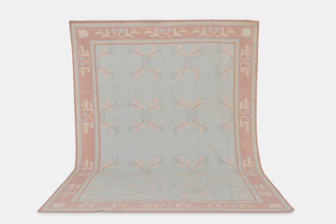 A cotton dhurrie carpet, mid-20th century, Indian,: A cotton dhurrie carpet, mid-20th century, Indian, woven with geometric motifs in pastels to a pale-blue ground (351 x 261cm) Condition Report: Please note: although we try to reproduce colours as clo