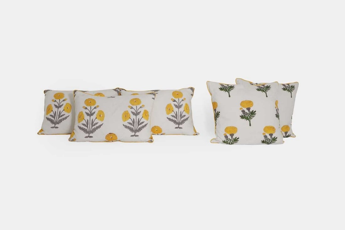A set of five cushions by Birdie Fortescue, of recent manufacture,: A set of five cushions by Birdie Fortescue, of recent manufacture, of Indian block-printed cotton, decorated with marigolds on a white ground, each with a yellow backing (39 x 56cm) (5) Condition Repo