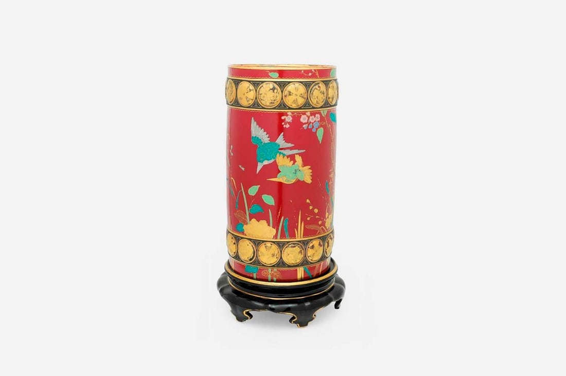 A glazed earthenware vase in the manner of Minton Pottery, late 19th century, possibly by Charles: A glazed earthenware vase in the manner of Minton Pottery, late 19th century, possibly by Charles Toft, of cylindrical form, decorated in the Japanese taste with birds, butterflies and foliage on a pu