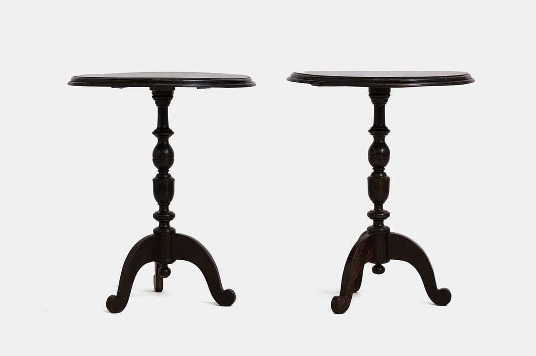 A pair of ebony side tables, 19th century, Anglo-Ceylonese,: A pair of ebony side tables, 19th century, Anglo-Ceylonese, each with an ogee moulded circular top, raised on a turned baluster column terminating in a tripod base (63cm diameter, 79cm high) (2) Condi