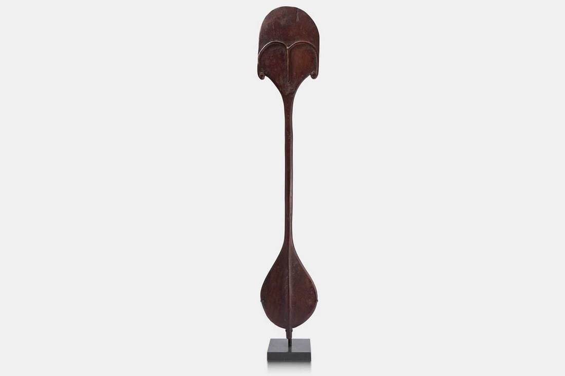 A Rapa Nui dance paddle or 'rapa', first half of the 20th century, Easter Island,: A Rapa Nui dance paddle or 'rapa', first half of the 20th century, Easter Island, carved wood, of figural form, with two blade-shaped lobes (120.3cm long) Footnote: Rapa Nui, commonly known as Easter 