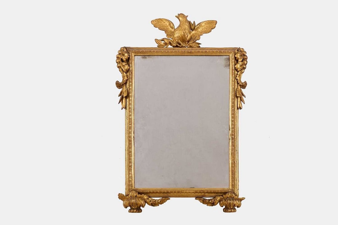 A giltwood pier mirror, 19th century,: A giltwood pier mirror, 19th century, with a rectangular mirror plate, surmounted by an eagle crest (64cm wide, 6.5cm deep, 103cm high)