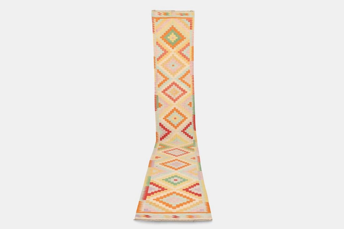 A flat-weave wool runner of Anatolian design, of recent manufacture,: A flat-weave wool runner of Anatolian design, of recent manufacture, woven with repeating geometric motifs in polychrome tones (496 x 80cm) Condition Report: Overall the piece presents in very good st