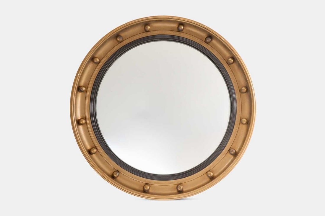 A group of seven giltwood convex mirrors, 20th century,: A group of seven giltwood convex mirrors, 20th century, each with a different frame (smallest 40.5cm diameter; largest 57cm diameter) (7)