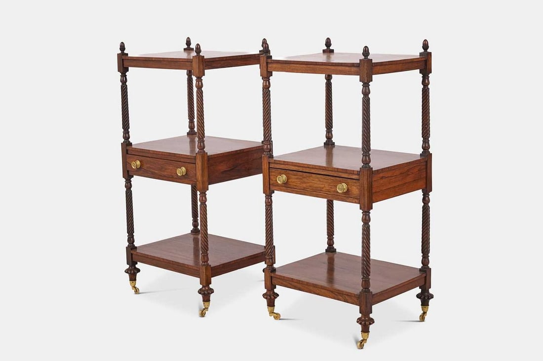 A pair of George IV rosewood étagères, circa 1825, Irish,: A pair of George IV rosewood étagères, circa 1825, Irish, each composed of three tiers, the central tier fitted with a short drawer, raised on spiral-twist supports surmounted by acorn finials and t