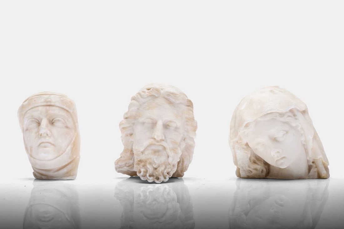 A collection of three carved alabaster fragments, 20th century,: A collection of three carved alabaster fragments, 20th century, comprising sculptural heads of Zeus, the Virgin Mary and a shrouded figure (shrouded figure 10.5cm wide, 7.5cm deep, 16cm high; Zeus 13c