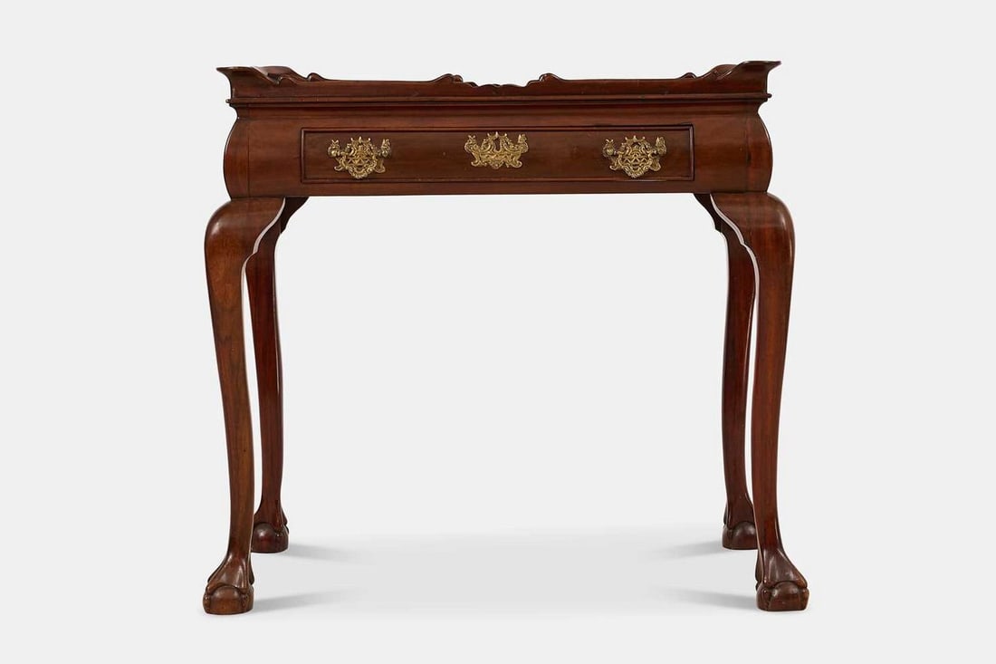 A mahogany silver table, second half of the 18th century, Dutch,: A mahogany silver table, second half of the 18th century, Dutch, the twin-handled, rectangular, galleried top over a frieze drawer, raised on cabriole legs terminating in ball-and-claw feet (80cm wide