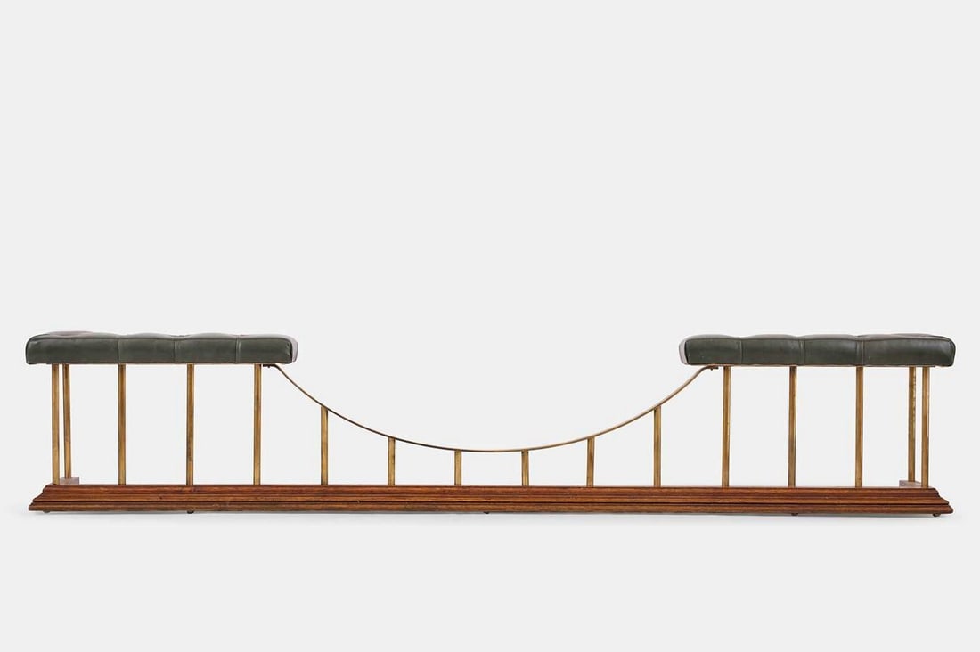 A large brass, oak and leather club fender, of recent manufacture,: A large brass, oak and leather club fender, of recent manufacture, with a buttoned seat, tubular supports and a stepped base (241cm wide, 30cm deep, 48cm high) Condition Report: Internally 208cm wide 