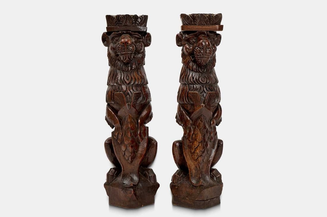 A pair of hardwood lion monopodia pedestals, 20th century,: A pair of hardwood lion monopodia pedestals, 20th century, intricately carved throughout, each with a detached capital (24cm wide, 24cm deep, 74cm high) (2) Condition Report: Both with a few relativel