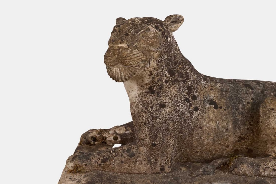 A marble sculpture of a lioness, late 19th/early 20th century,: A marble sculpture of a lioness, late 19th/early 20th century, modelled in a recumbent position, mounted on an integral plinth base (71cm wide, 44cm deep, 47cm high)