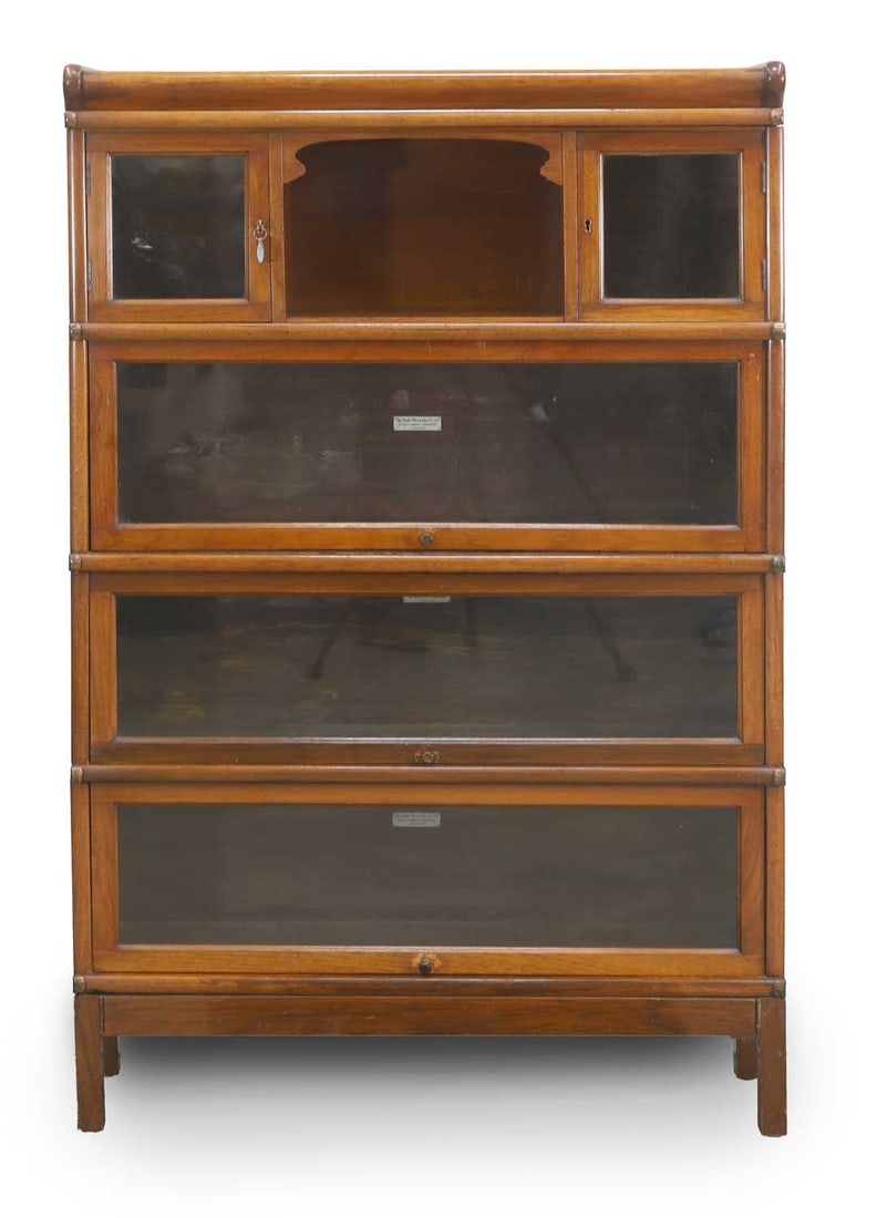 A Globe Wernicke glazed bookcase, early 20th century,: A Globe Wernicke glazed bookcase, early 20th century, the top section with two glazed doors flanking a centre section, above three typical style glazed lift front bookcase sections, over square