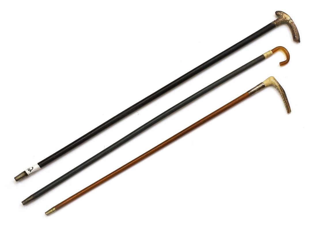 Three children's walking canes, late 19th century,: Three children's walking canes, late 19th century, with horn, brass and a plastic handle, one silver-mounted 65cm, 61cm and 53cm long 3 Condition Report: Worn.