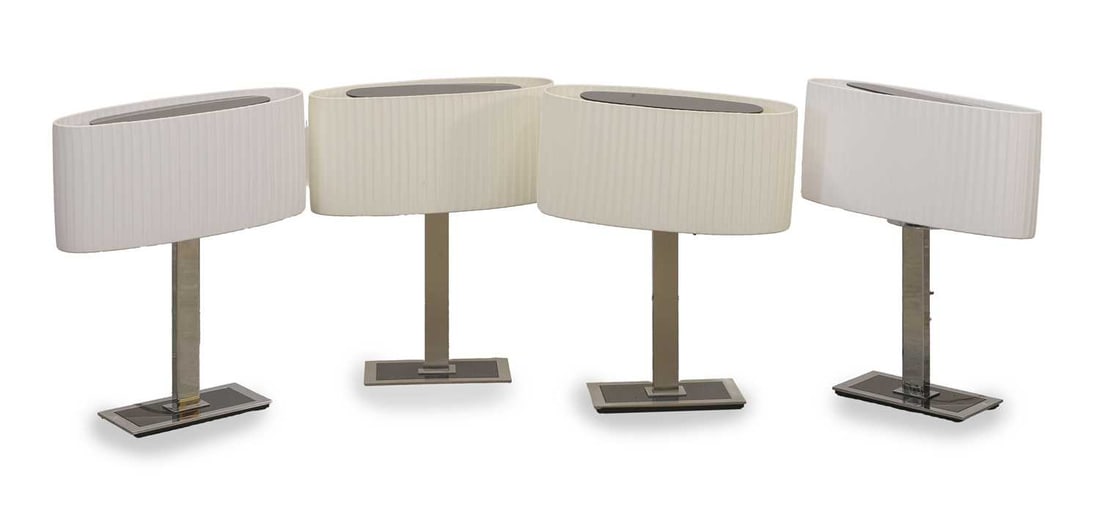 A group of four Bover ovular form lamps, of recent manufacture,: A group of four Bover ovular form lamps, of recent manufacture, each with white ruffled shade, on chrome support, with black inlay centre to the rectangular base 41cm wide, 44.5cm high Condition