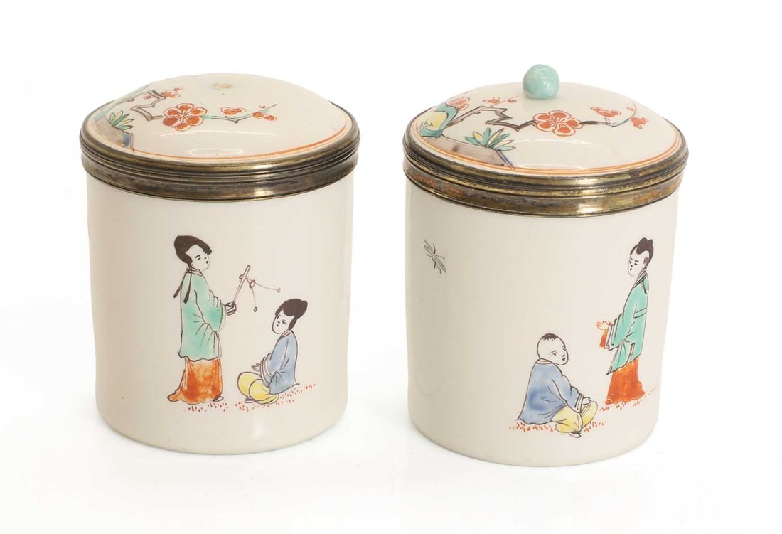 A pair of pounce pots, probably Chantilly, circa 1762-1768,: A pair of pounce pots, probably Chantilly, circa 1762-1768, decorated in the kakiemon style, with silvered mounts, one finial missing, each with the bugle mark 6.5cm high 2 Condition Report: One