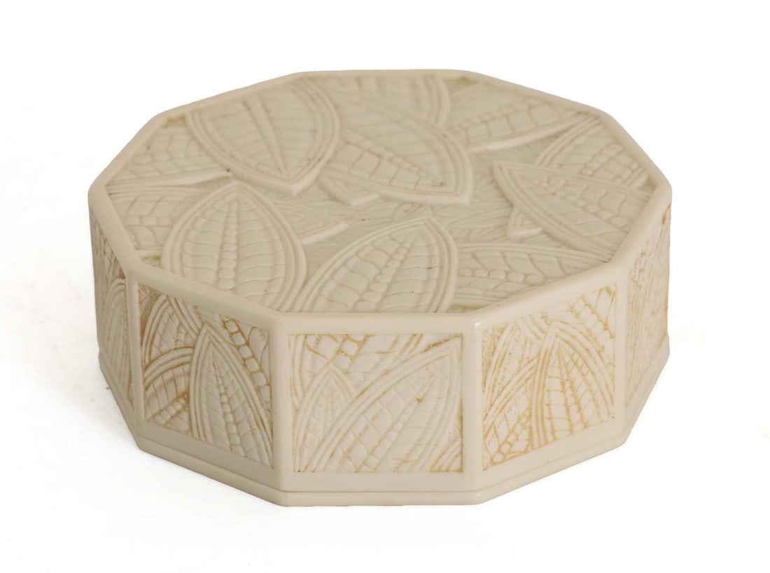 An Art Deco ten sided phenolic box, circa 1920s,: An Art Deco ten sided phenolic box, circa 1920s, designed by Eduard Fornells (1887-1942) the lid and panel sides with stylised foliage, unmarked 10cm diameter Condition Report: Fair overall.