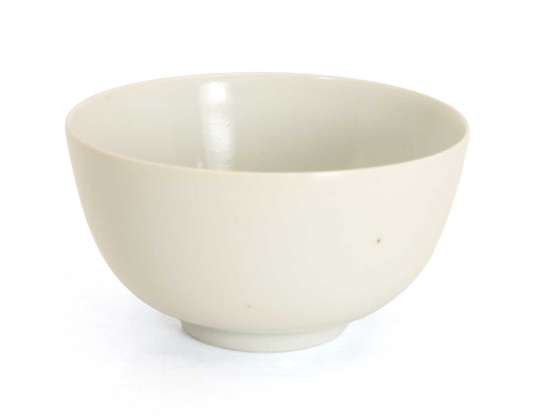A Chinese white-glazed bowl,: A Chinese white-glazed bowl, of circular form and raised on a short foot, bearing a six-character Yongzheng mark to base 12cm diameter Condition Report: Residue from sticker to the interior and