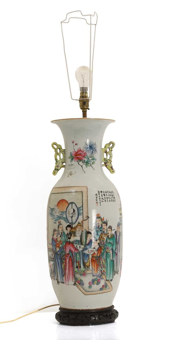 A Chinese famille rose vase, 20th century,: A Chinese famille rose vase, 20th century, of baluster form rising to an everted rim, the neck flanked by twin pierced handles, one side painted with scholarly figures, boys and calligraphy, the