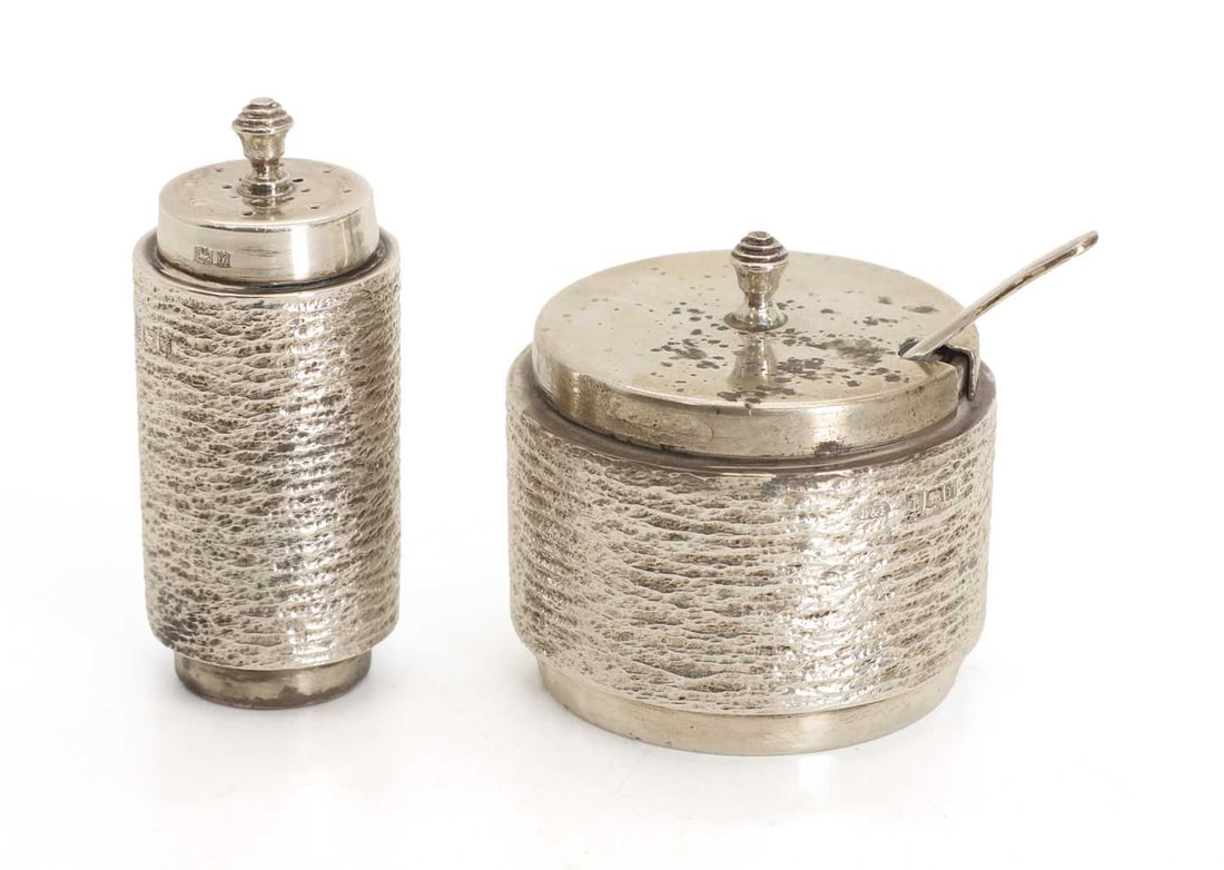 A silver two piece condiment set, by Deakin and Francis, Birmingham, 1973: A silver two piece condiment set, by Deakin and Francis, Birmingham, 1973 each piece of cylindrical form, with a textured banding, with a glass liner and spoon 6.5cm high, 5cm diameter, 2.8ozt 3 Condi