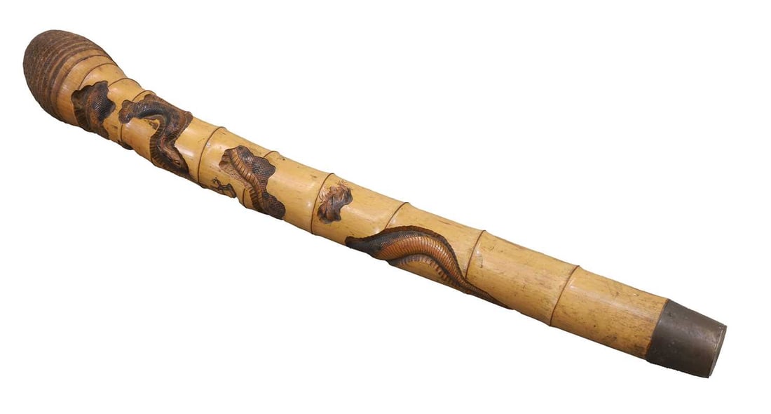 A Chinese bamboo sceptre, early 20th century,: A Chinese bamboo sceptre, early 20th century, decorated with a snake and a frog to the bamboo shaft, in various forms of carved and etched, the end with a brass tapering cap 15cm wide, 106cm high