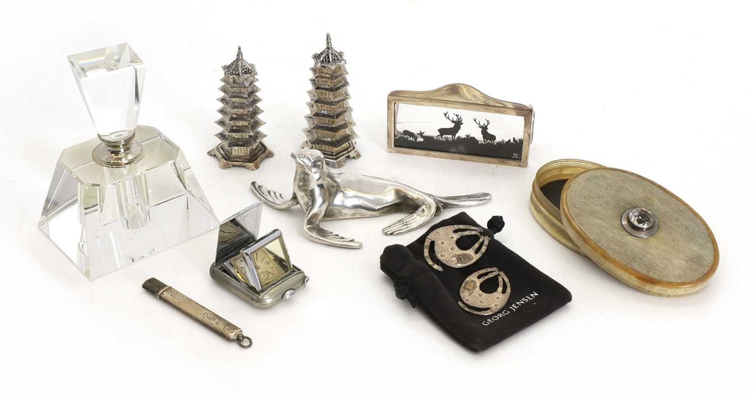 A pair of Chinese silver pagoda form pepperettes, circa 1900,: A pair of Chinese silver pagoda form pepperettes, circa 1900, an Elkington and Co silver menu holder, with a glass silhouette of stags, a silver mounted pencil, a Huber chrome-cased pocket watch, a