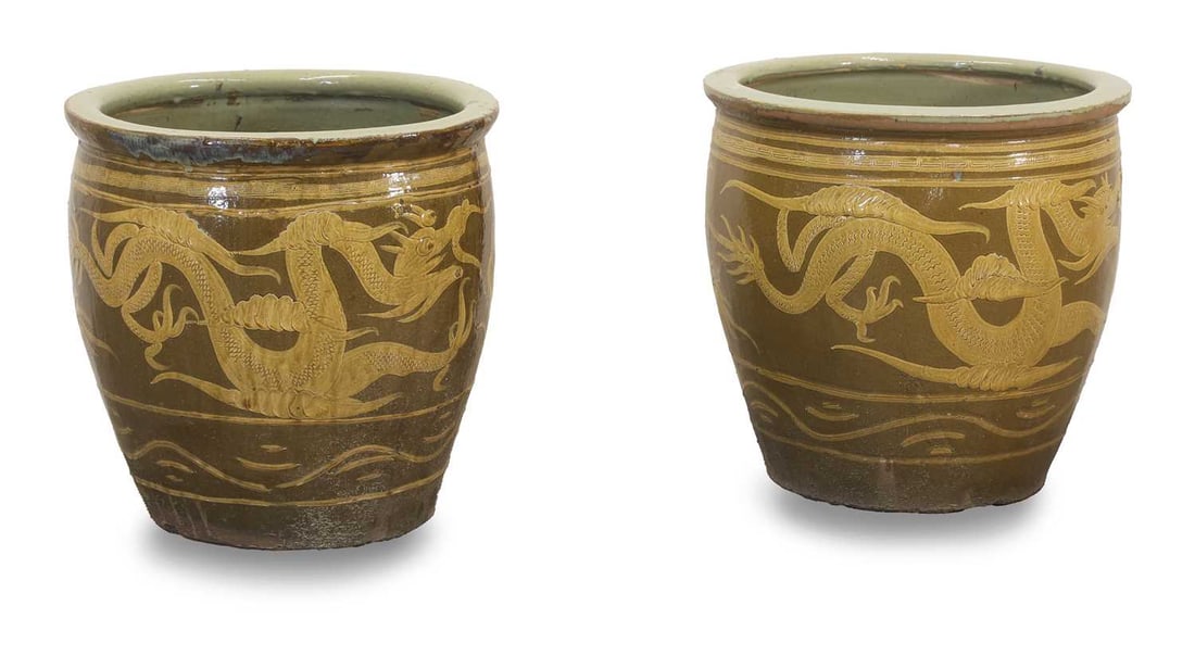 A pair of Chinese stoneware dragon bowls, of recent manufacture,: A pair of Chinese stoneware dragon bowls, of recent manufacture, decorated with clouds and dragons, internally glazed in teal, with drainage holes to base, 49cm wide, 50cm high Condition Report: