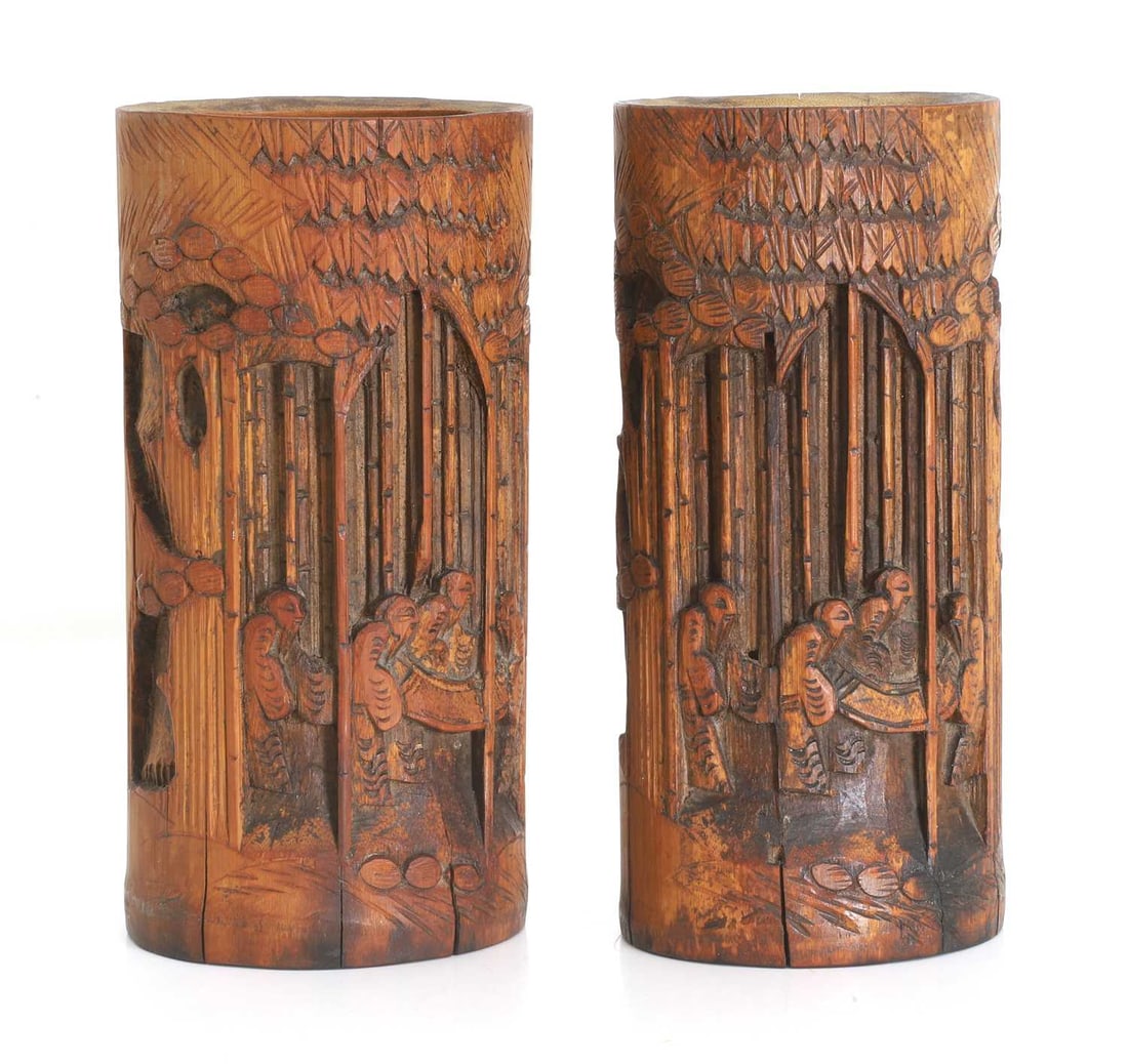 A pair of Chinese brush pots, late Qing dynasty,: A pair of Chinese brush pots, late Qing dynasty, decorated with carved figural scene, with scholars within a bamboo forest 9.8cm wide, 20cm high q Condition Report: some splits