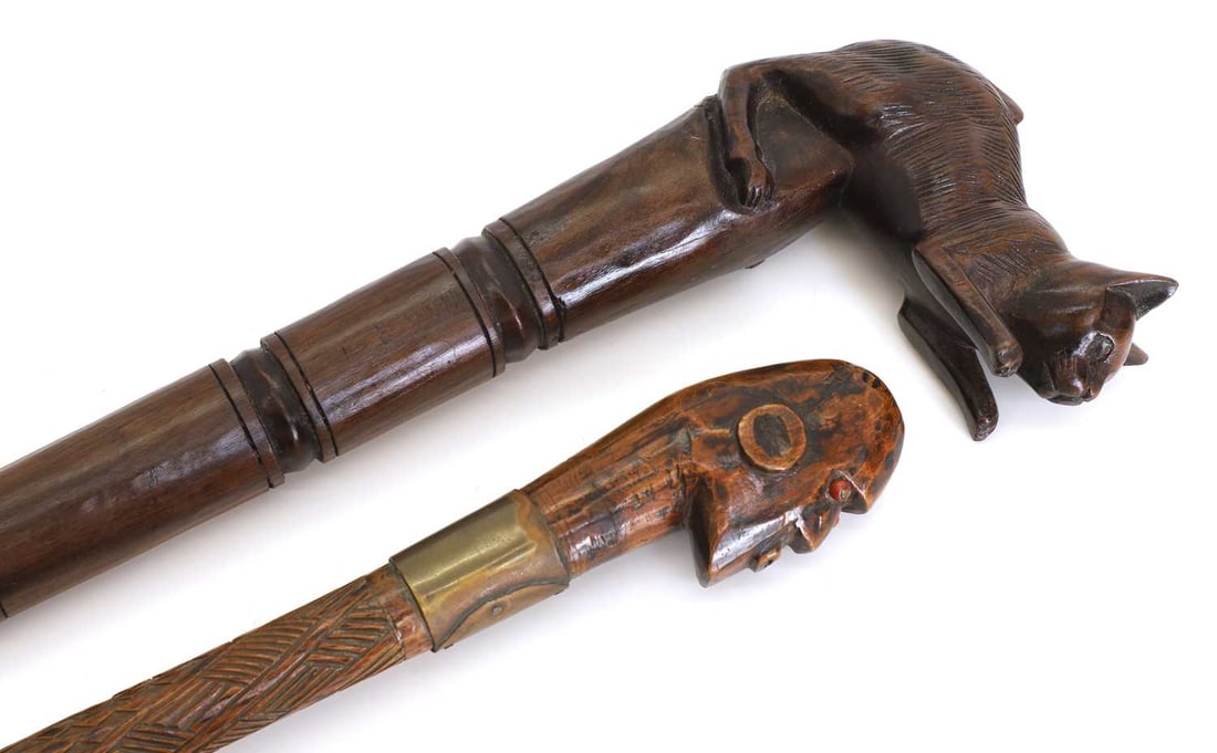 A tribal carved walking stick and another carved with a cat, early 20th century, - 2