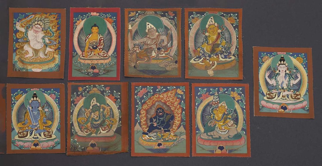 Nine Tibetan thangkas,: Nine Tibetan thangkas, of small size, of various Buddhist deities, including Avalokiteshvara, Mahakala, and Jambhala, opaque pigment on cloth 15.5 x 13cm 9 Condition Report: Some fraying to the edges