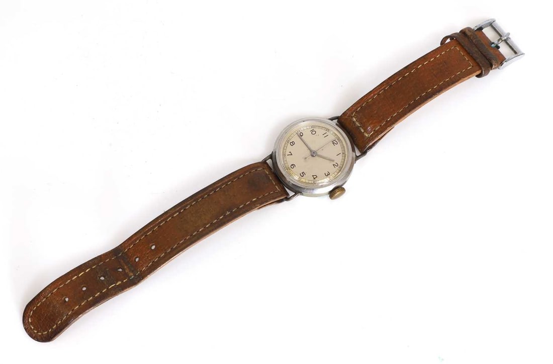 A Dennison WWII military issue mechanical wristwatch, circa 1942,: A Dennison WWII military issue mechanical wristwatch, circa 1942, with a cream dial with black printed Arabic hour and five-minute markers, with a 16-jewel movement, no.7013, in a plain steel Dennison