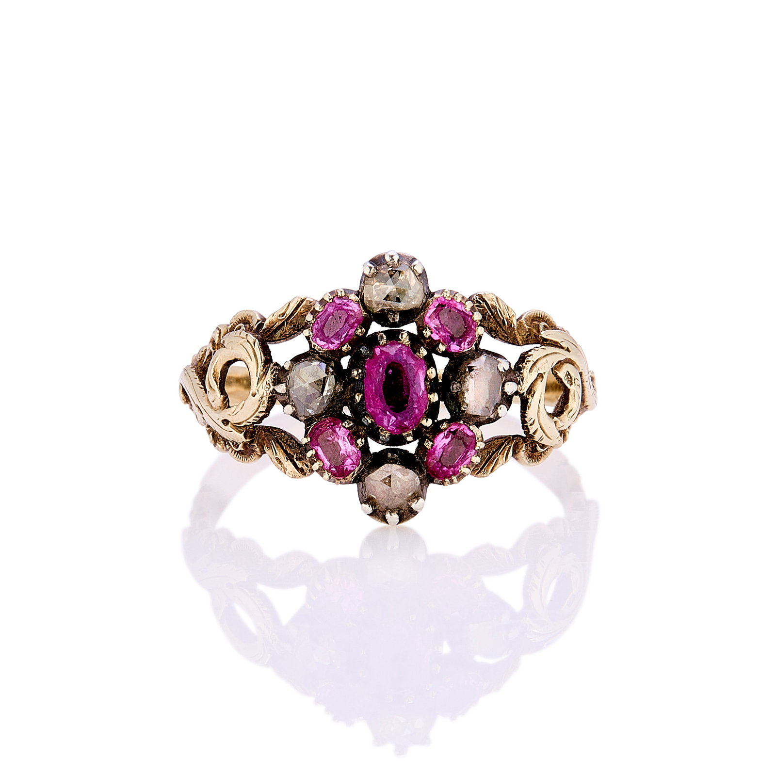 A Georgian ruby and diamond cluster ring,: A Georgian ruby and diamond cluster ring, the central cluster of oval shaped pinkish rubies and rose cut diamonds in foiled back settings, with scrolling acanthus leaf detail to shoulders and a groove