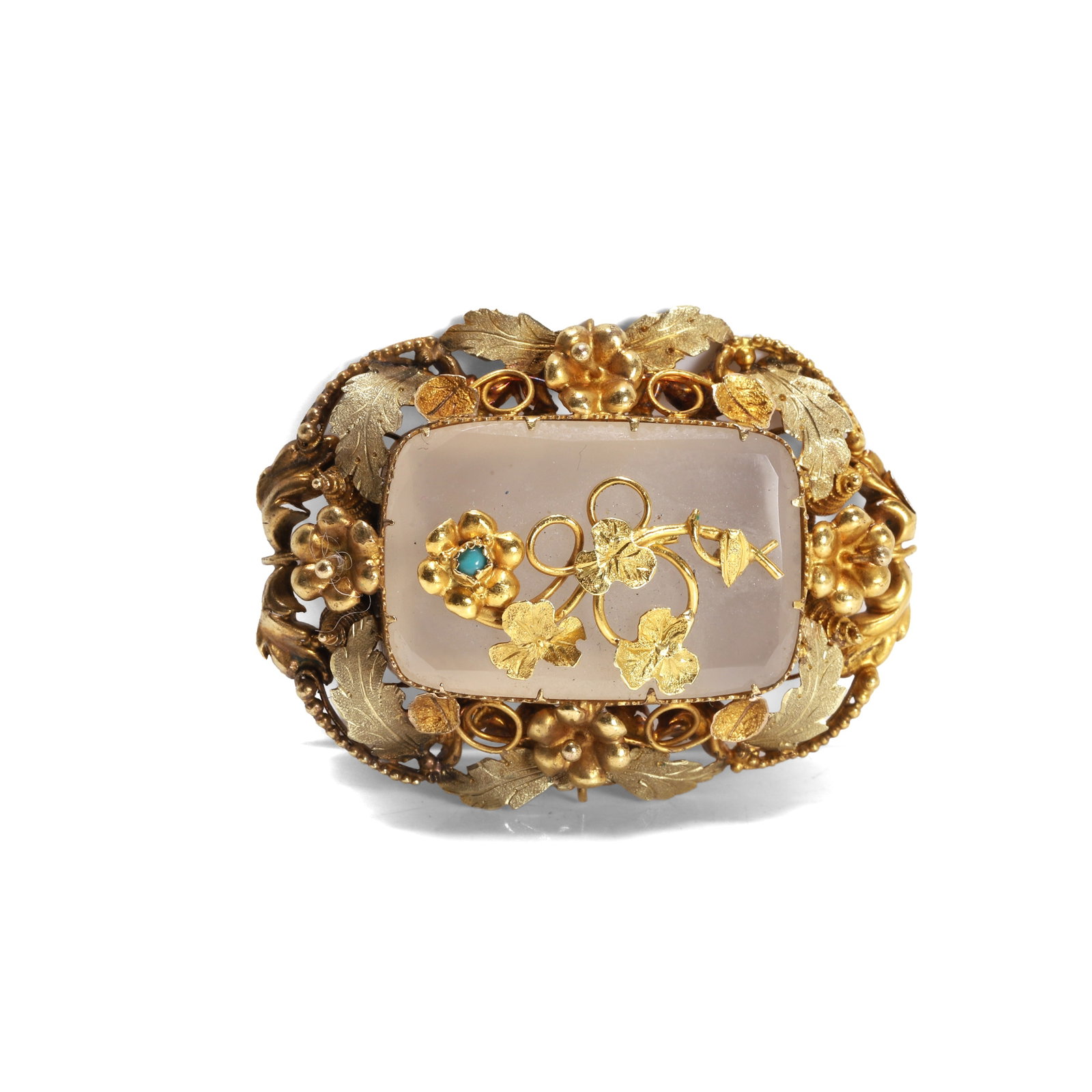 A Victorian chalcedony foliate brooch,: A Victorian chalcedony foliate brooch, the cushion shaped chalcedony plaque applied with a turquoise set forget-me-not motif, in a textured floral surround with cannetille and granulation detail,