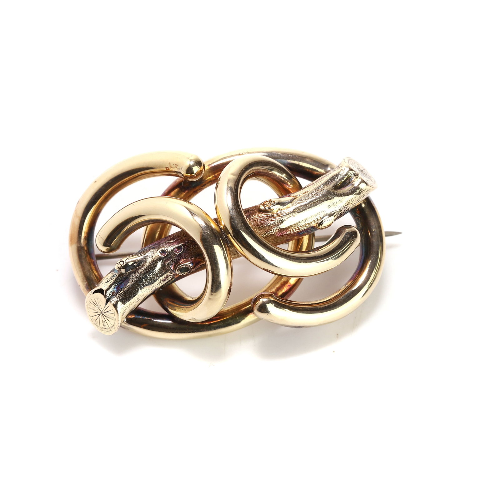 A lovers knot brooch,: A lovers knot brooch, enclosing a branch motif, unmarked and surface tested as approximately 14ct gold, to a base metal pin (Length 5cm; 8.8g) Condition Report: Replacement clasp. Base metal pin.