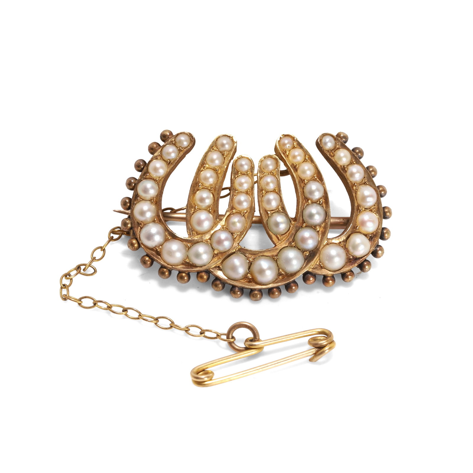 A late Victorian split pearl horseshoe brooch,: A late Victorian split pearl horseshoe brooch, designed as a triple horseshoe motif, set with graduated split pearls, to a beaded border, with pin and C catch, unmarked and tested as approximately