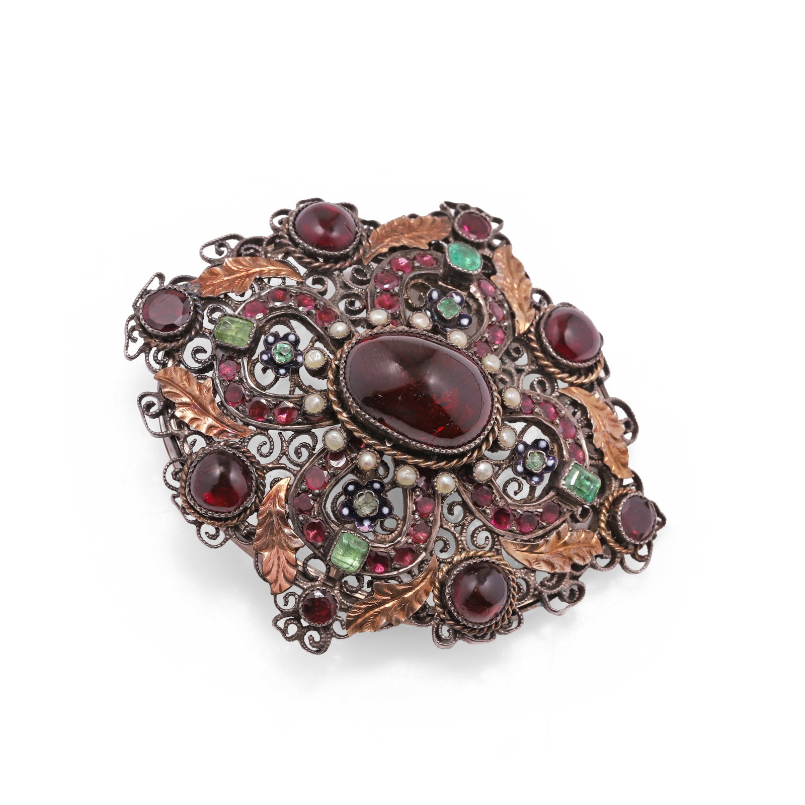 A garnet, emerald and split pearl Holbeinesque locket brooch,: A garnet, emerald and split pearl Holbeinesque locket brooch, the central quatrefoil design set with an oval cabochon garnet within a wire twist and split pearl border, surrounded by lines of faceted 